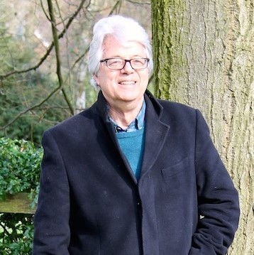 Anthony Burton standing outside by a tree