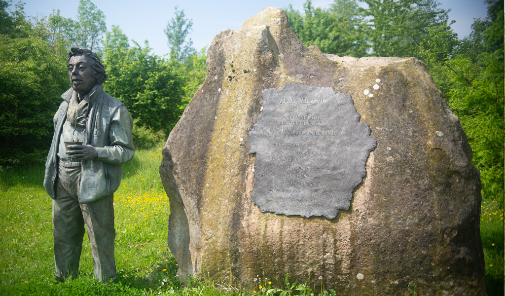 The statue of Felix Dennis and the Founder's Rock in Dorsington Wood.