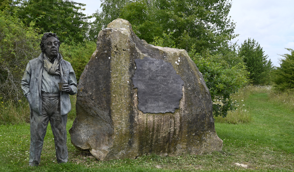 The statue of Felix Dennis and the Founder's Rock in Dorsington Wood.