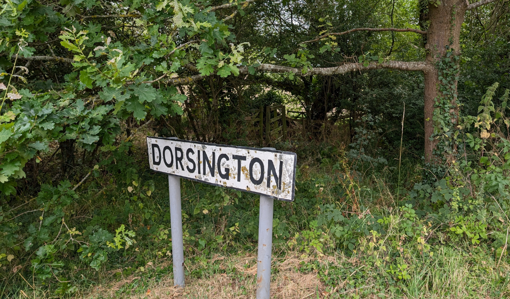 A road sign saying 'Dorsington' along the side of a road.