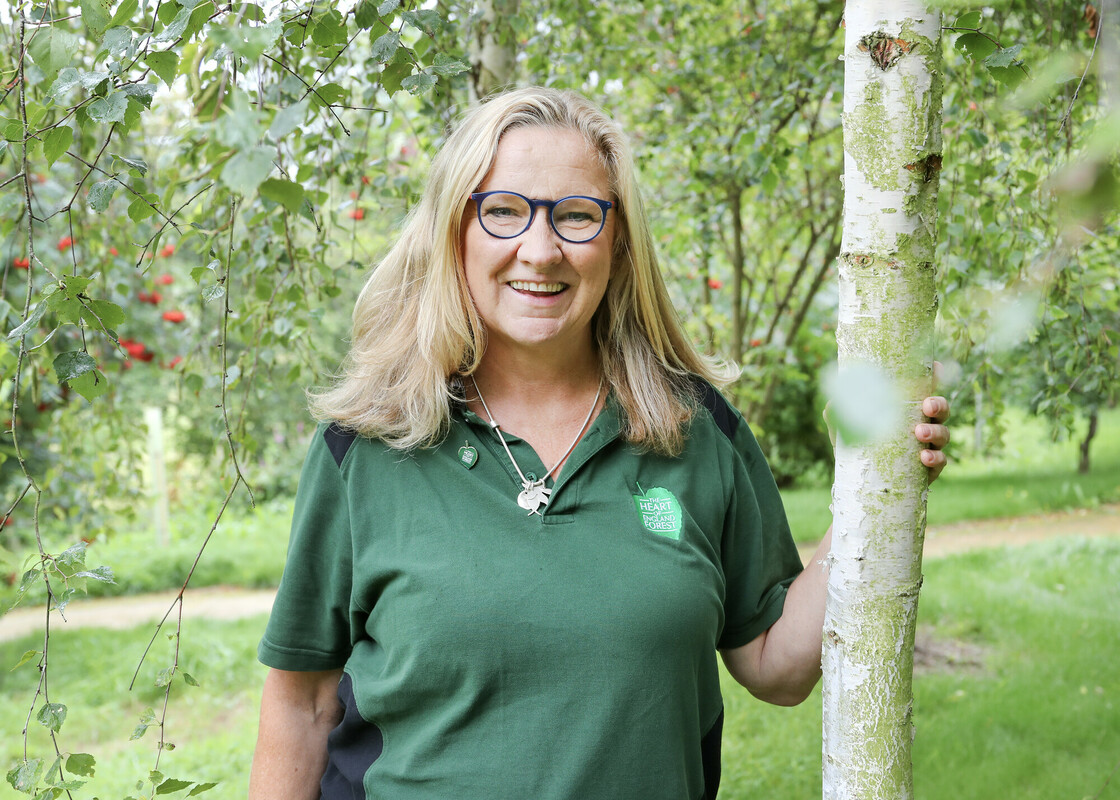 Fran Bos – Senior Corporate Partnerships Manager smiling at the camera in the Heart of the Forest