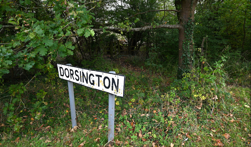 A road sign saying 'Dorsington' along the side of a road