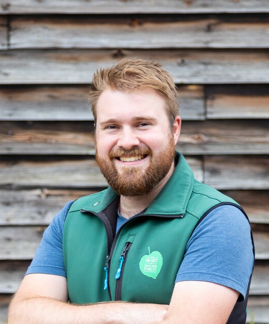 Jonathan Saunders, smiling at the camera wearing branding clothing