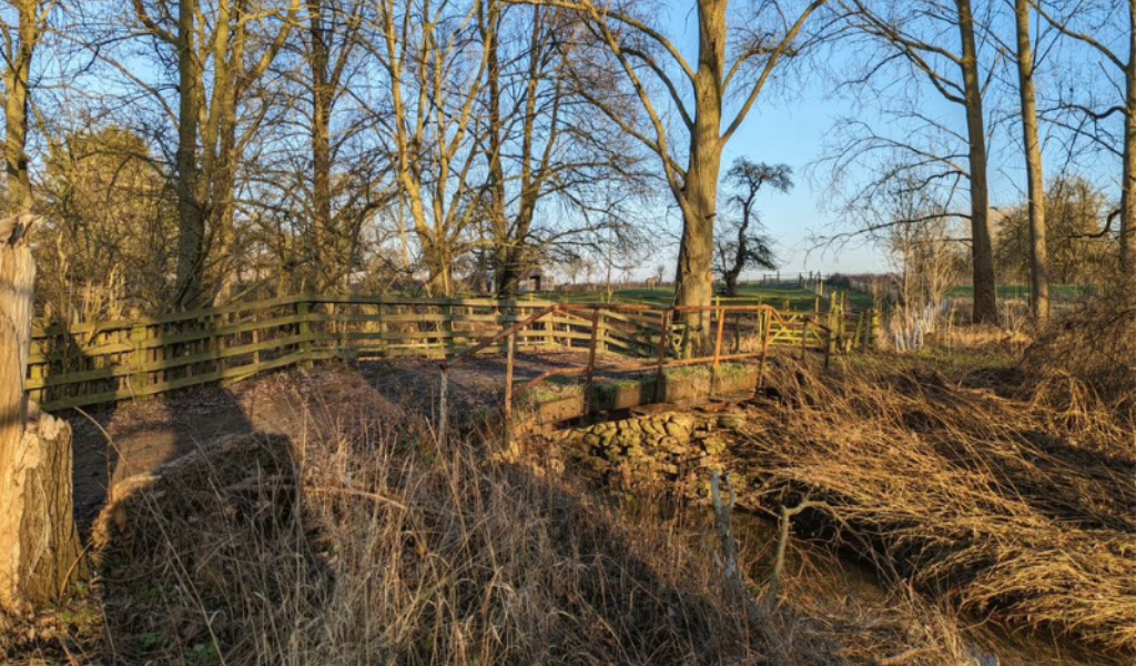 A concrete bridge over Noleham Brook, following the Founder's Walk route