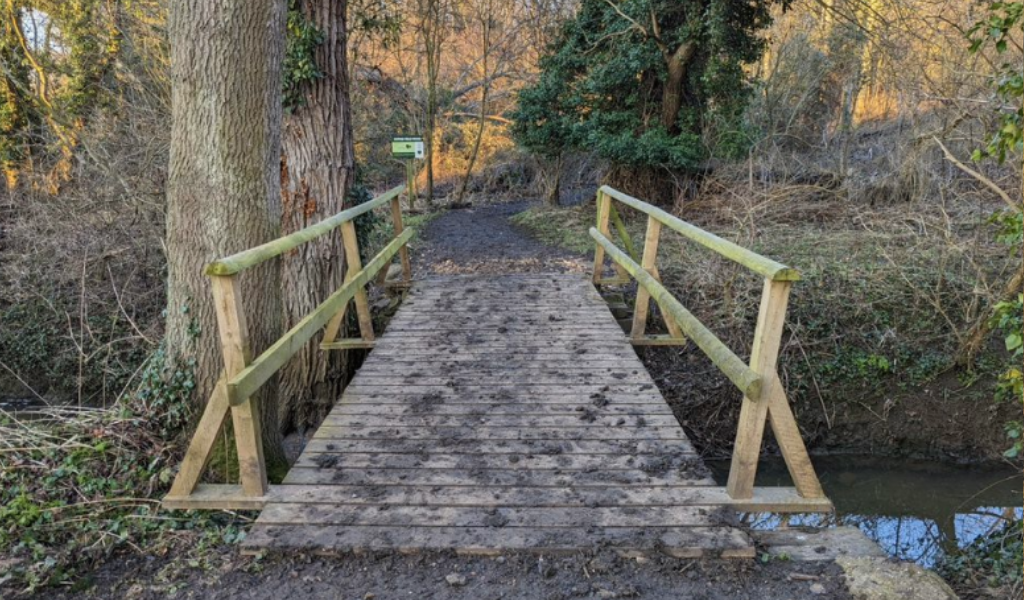 A wooden bridge crossing Noleham Brook