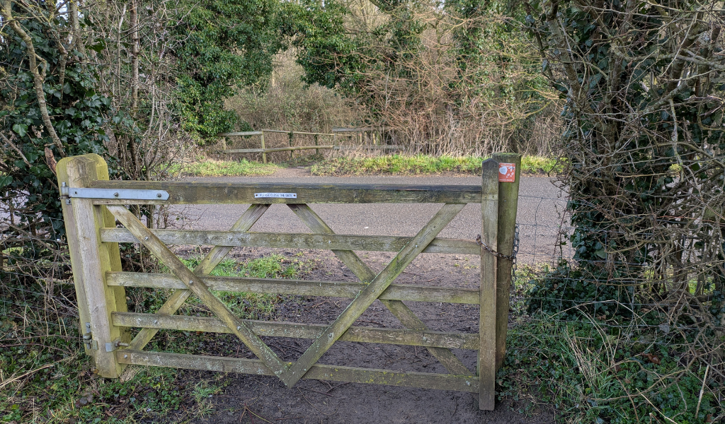 The gate at the bottom of the 'tree dedication' field leading to the road