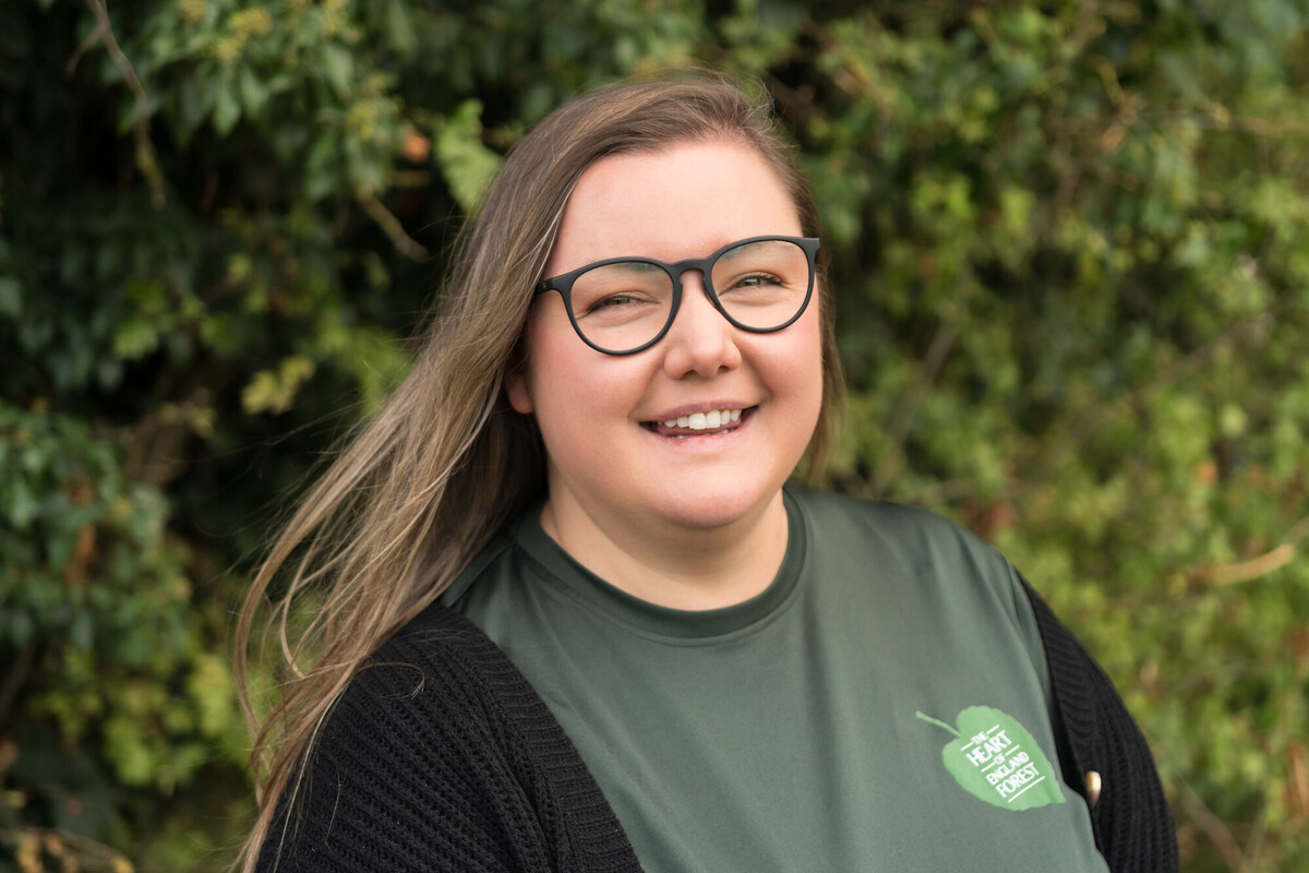 A photo of Sarah speaking with the public at an event.