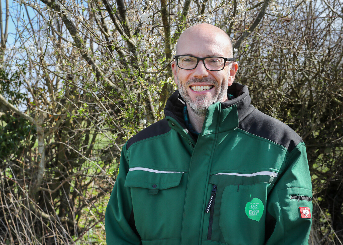 A head shot of Steve Eddy wearing branded clothing smiling at the camera 