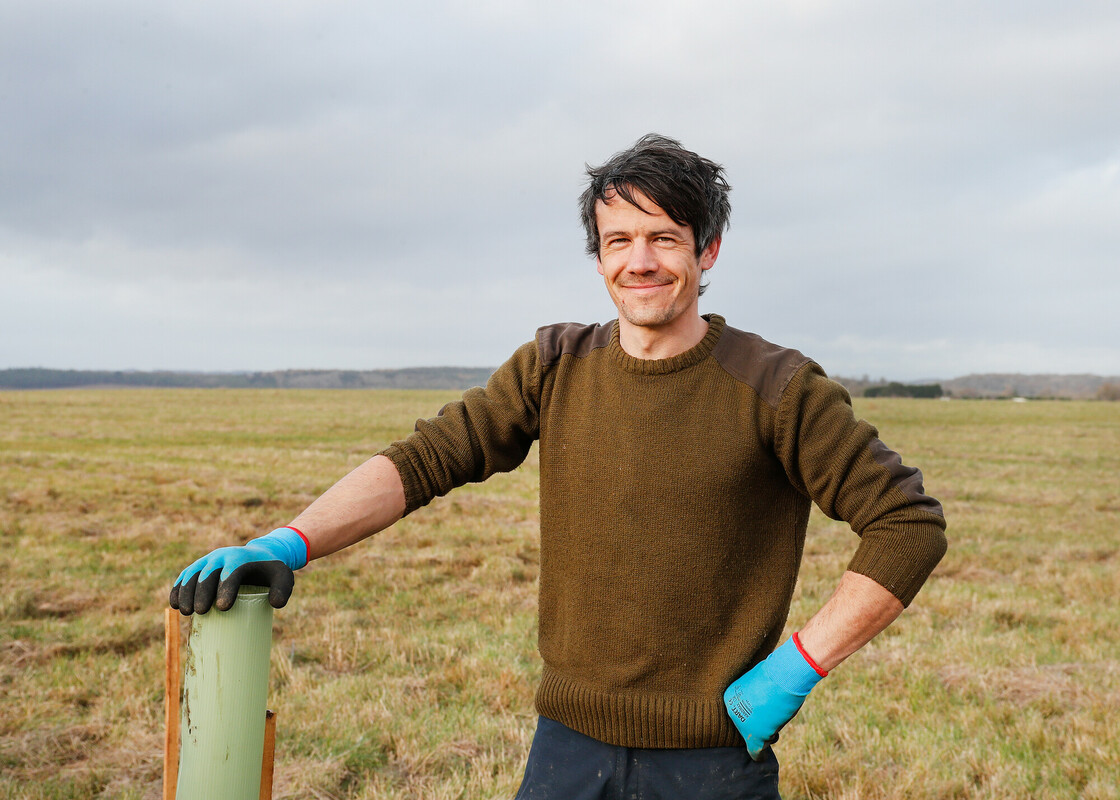 A smiling head shot of Ben Bek out in the field 