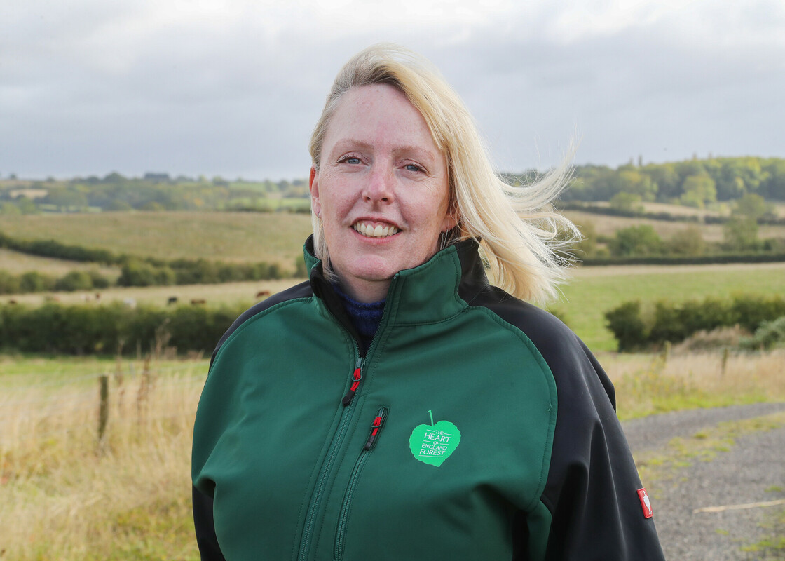 A photo of Emma Buckingham in branded clothing looking at the camera. 