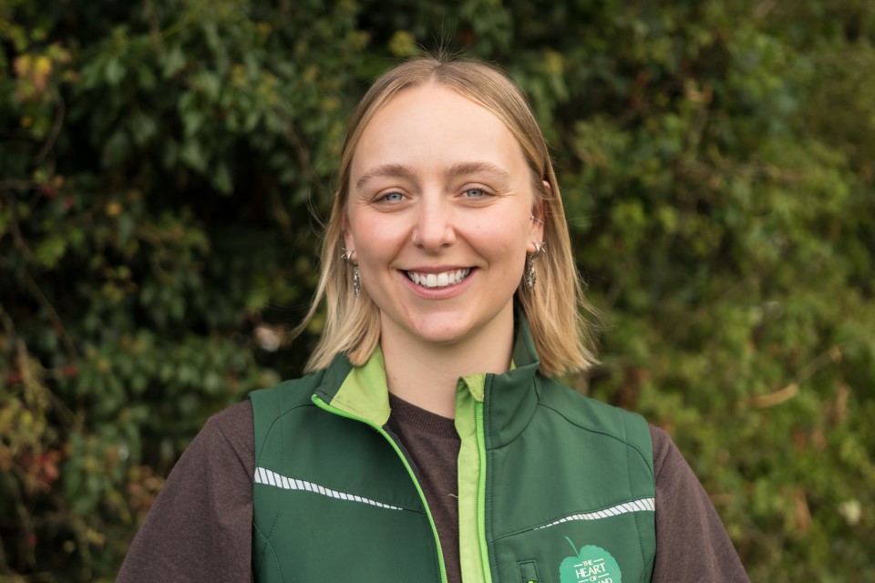 Emma Pestridge, Head and shoulders shot with a dark green hedgerow in the background