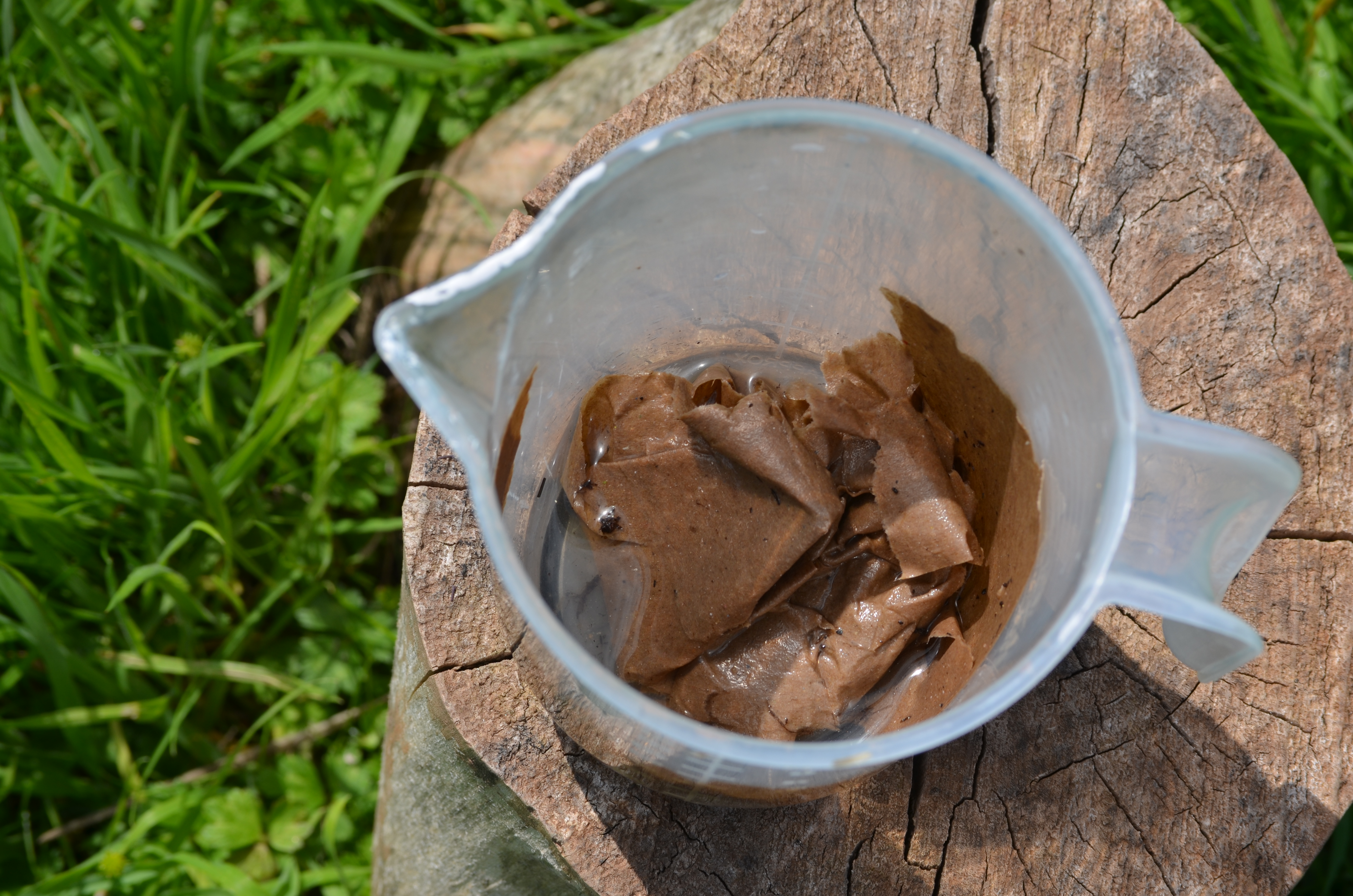 Brown paper mixed with water in a measuring jug