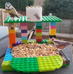 A homemade bird feeder made out of lego