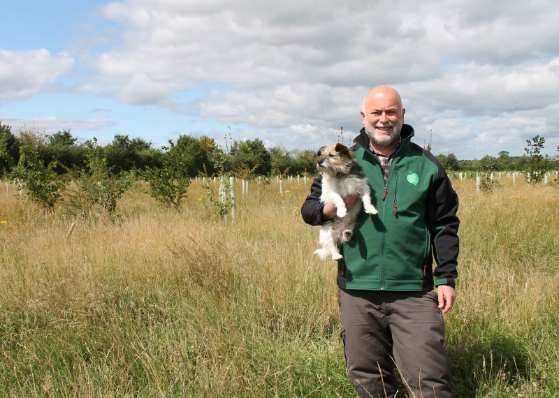 Phil holding his Jack Russel Jess in a young plantation