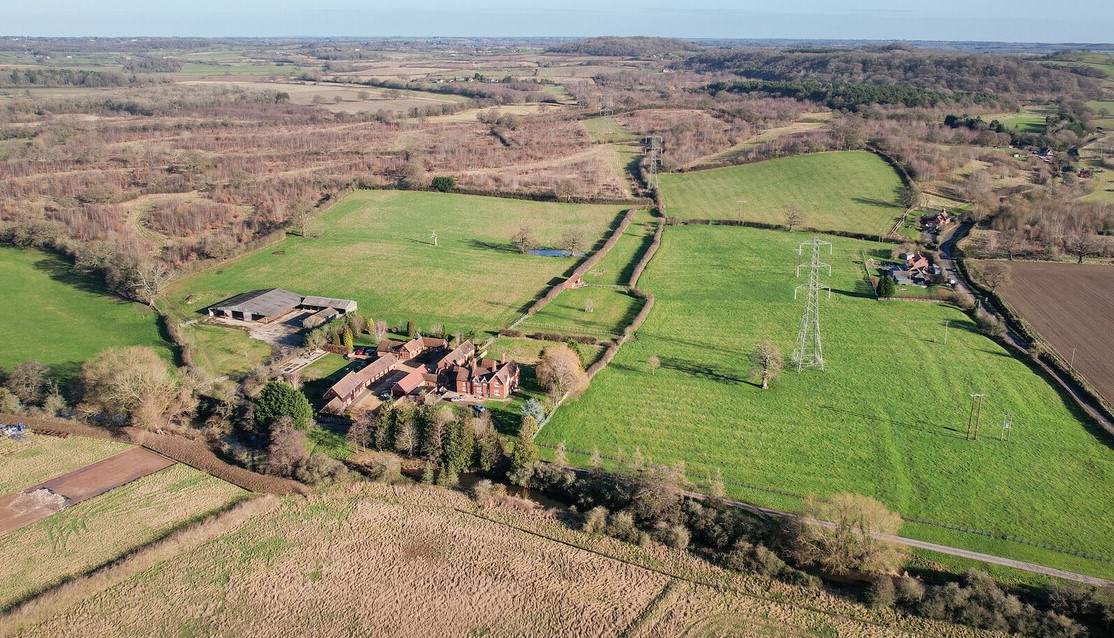 Aerial photo showing buildings, fields and trees on our land at Spernal Hall Farm