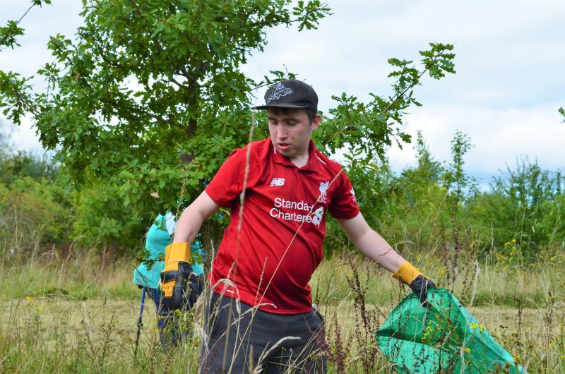 Supported intern Tom  removing tree guards in the Forest 