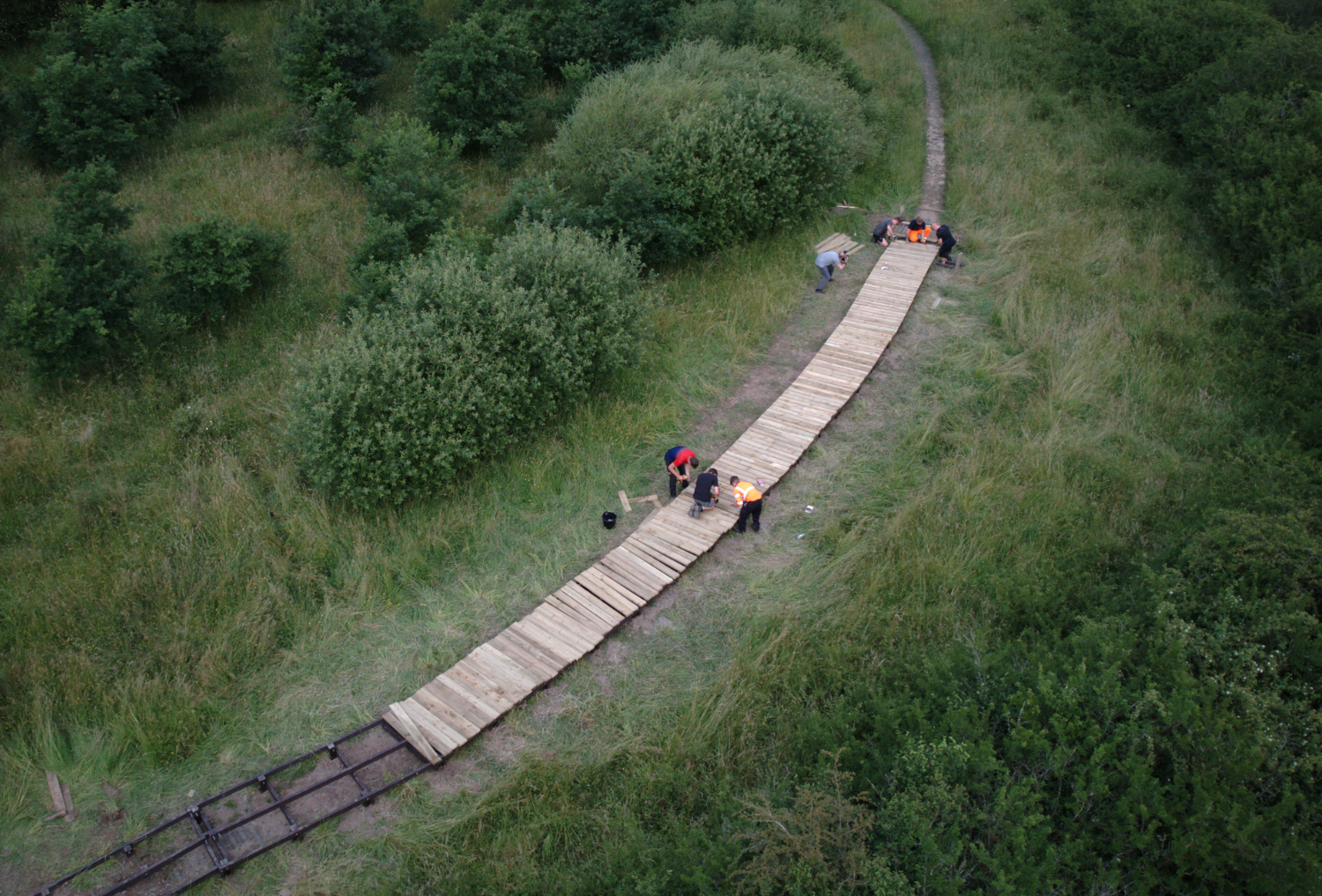 An aerial shot of National Grid apprentices constructing a boardwalk on the accessible trail at Morgrove Coppice