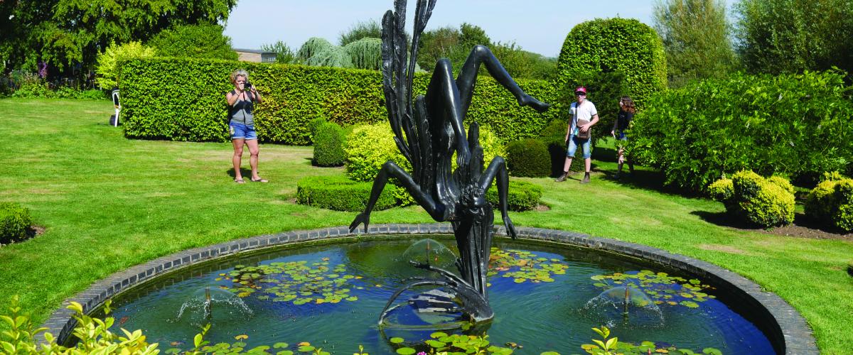 A water feature and statue at the Gardens of Heroes and Villains