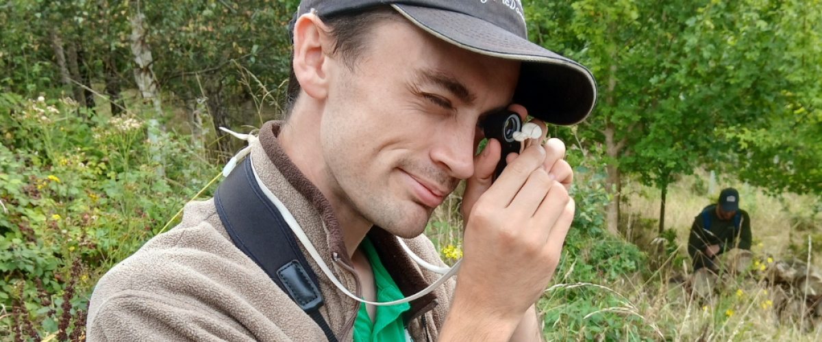 Sam using an eyepiece for a closer inspection