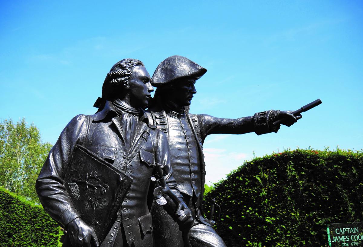 A sunny sculpture of two men in the garden of heroes and villains