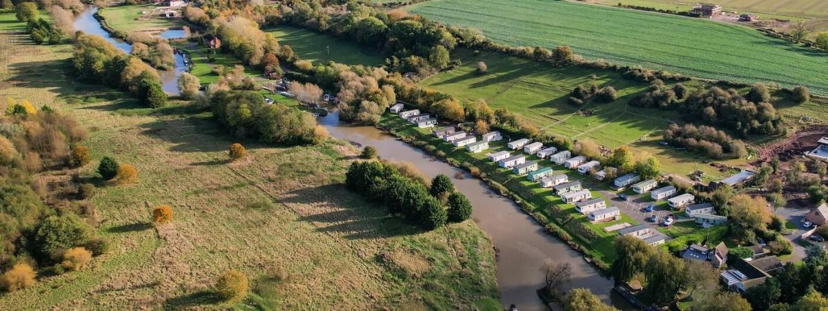 Aerial view of Dovecote static caravan park by the side of the River Avon in the Forest