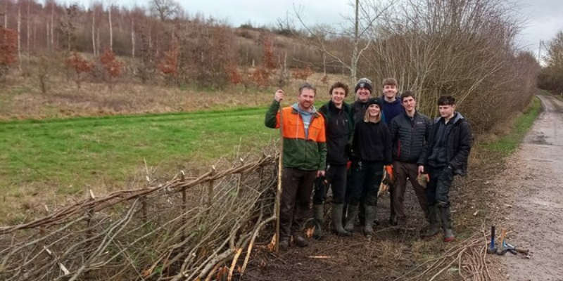 The forestry team standing proudly with the new hedgelaying skills showcased