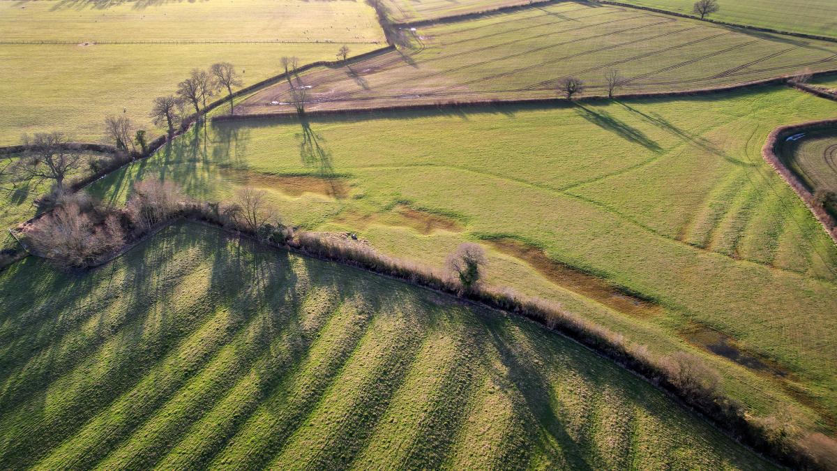 A drone image of the different habitats and land types of Naunton Beauchamp, furrows, arable land and SSSI 