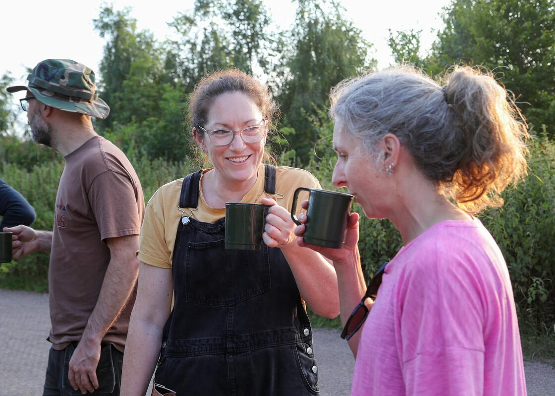 Two volunteers having a chat and a cup of tea