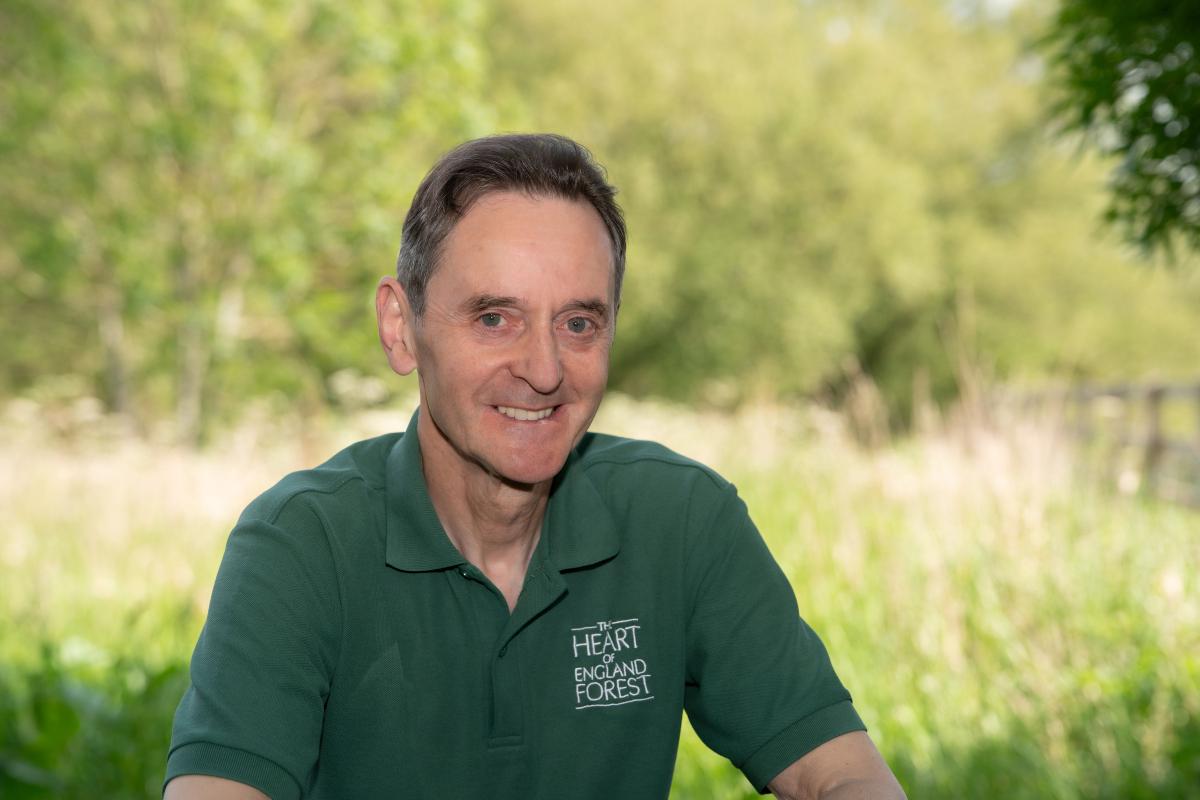 A photo of Paul Hirons leaning on a gate smiling