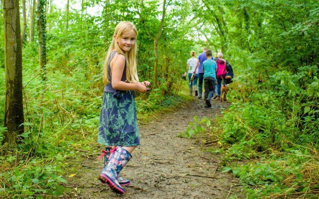 a young girl exploring the Forest routes in her wellies