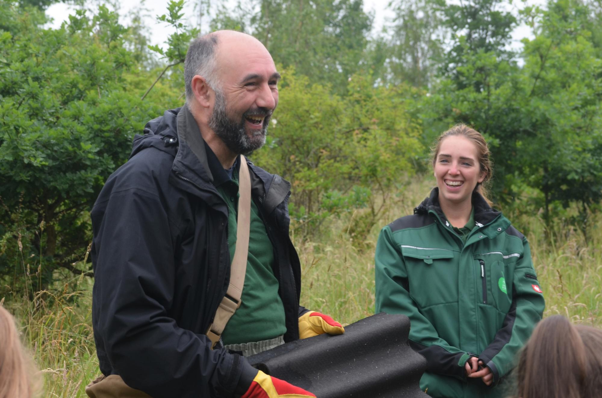 Staff members Emma and Ed laughing in the Forest