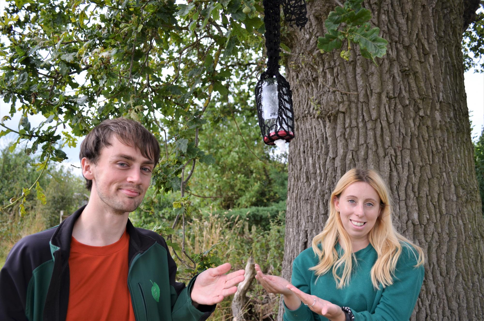 Sam and Ellie with their homemade jar butterfly feeder
