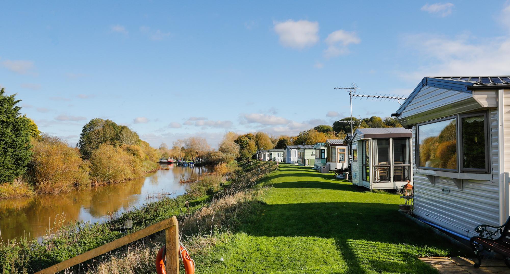 A row of static caravans with views of the River Avon at our caravan park 