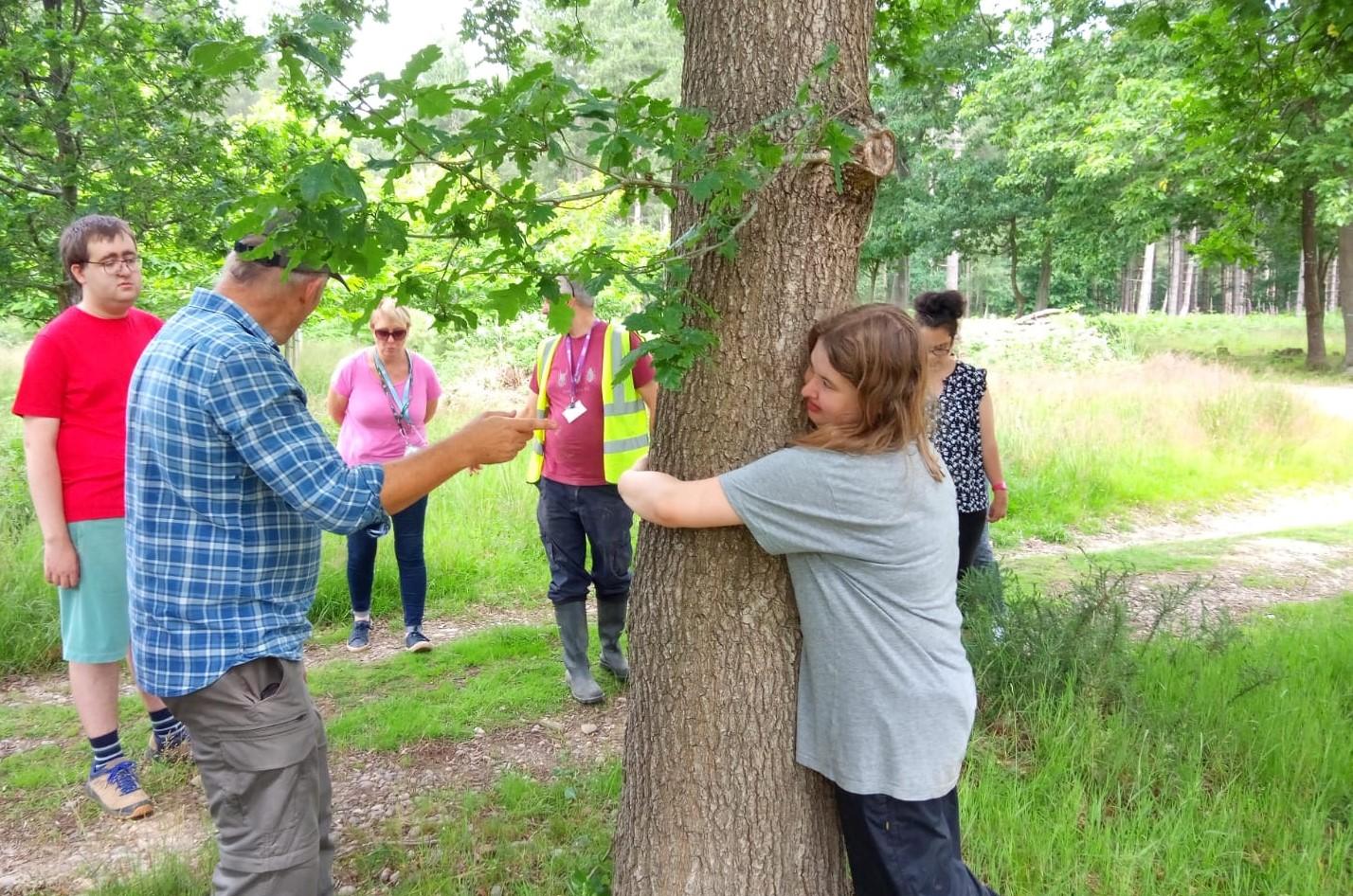 Ian from the Forest team working with a group of school students to measure the age of a tree in the Forest