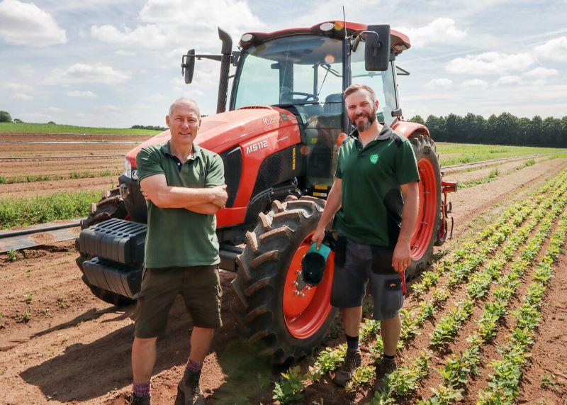 Assistant Tree Nursery Manager, Ian, and Tree Nursery Manager, Geza stood by a tractor at the tree nursery