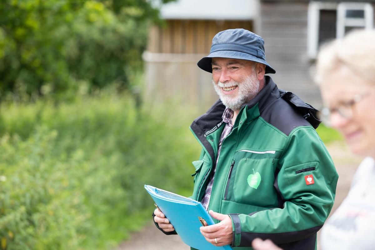 A picture of Outdoor Teacher Phil Stickley, smiling holding a clipboard.