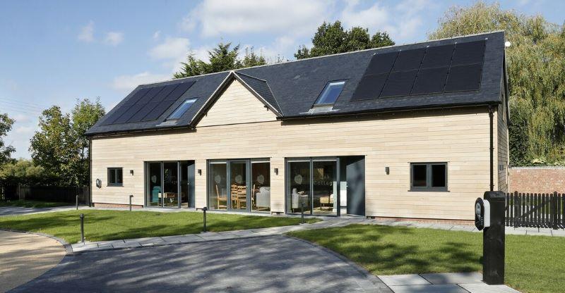 Exterior photo of two holiday cottages on a sunny day