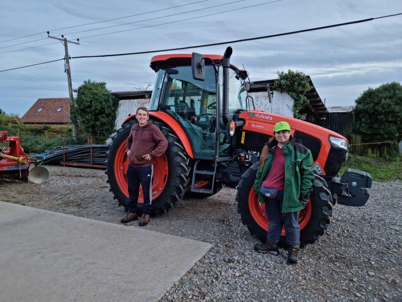 Matthew and Rhiannon in front of a tractor at Binton tree nursery