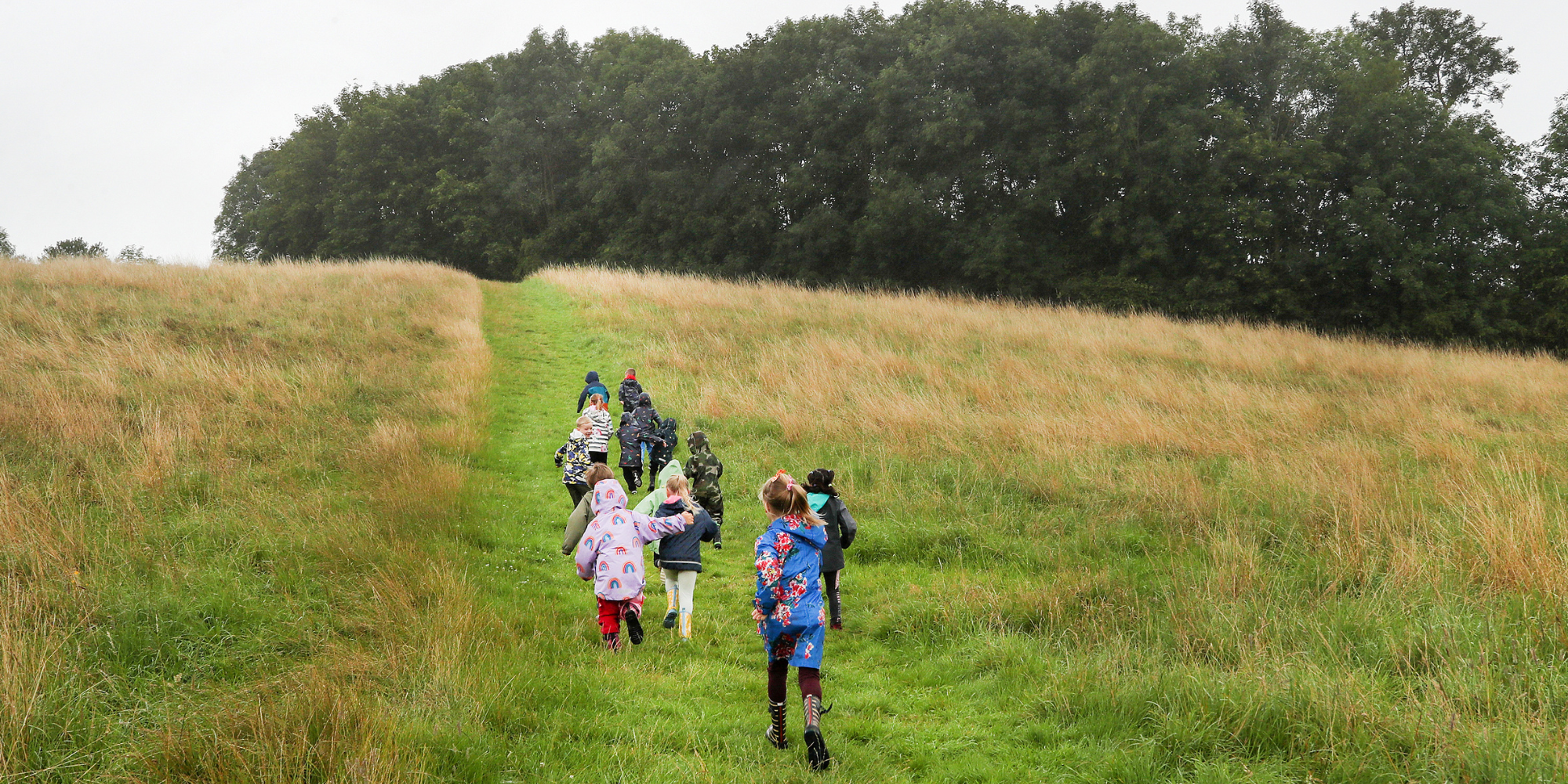 A group of children running up the hill at Middle Spernal.