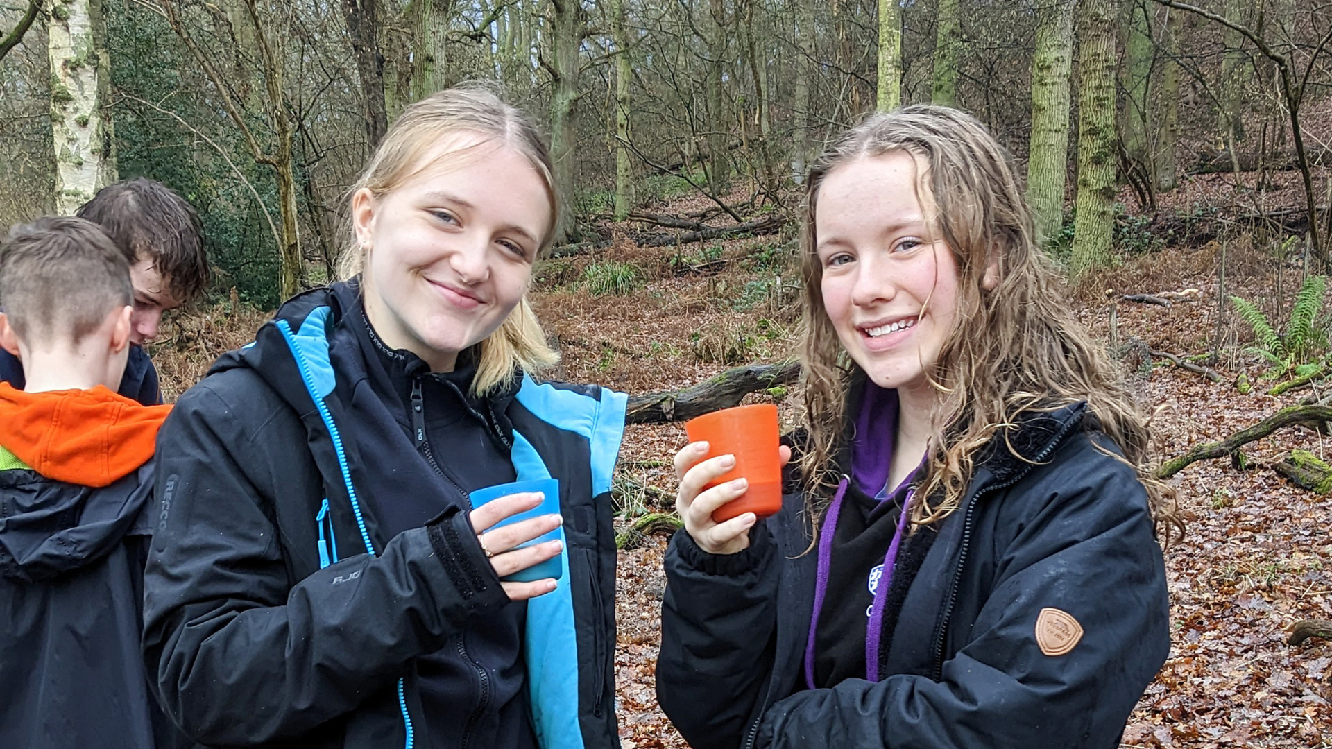 Despite the wet and cold months, these two young foresters are smiling at the camera with their hot chocolates