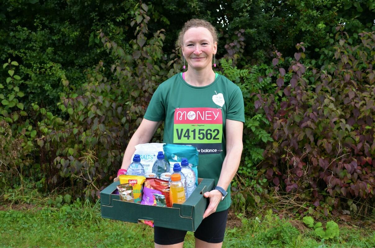 A photo of Liz holding a hamper for the virtual London Marathon 2021