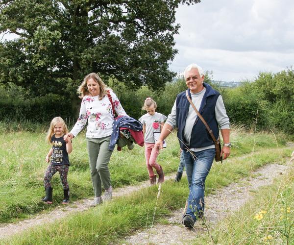 A family enjoying a walk through an open ride in the Forest