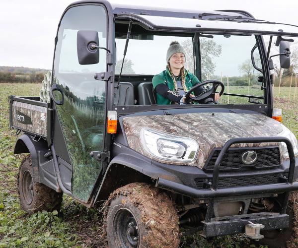 Intern Alicia driving a small 4x4 vehicle in the tree planting field 