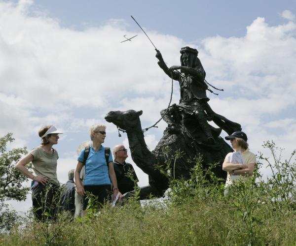 Visitors admiring the sculpture of Lawrence of Arabia