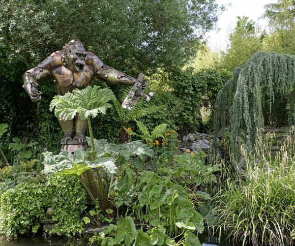 Sculpture of King Kong in a lush garden