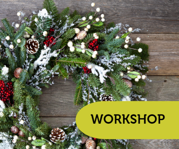 A handmade Christmas wreath lay on a wooden table