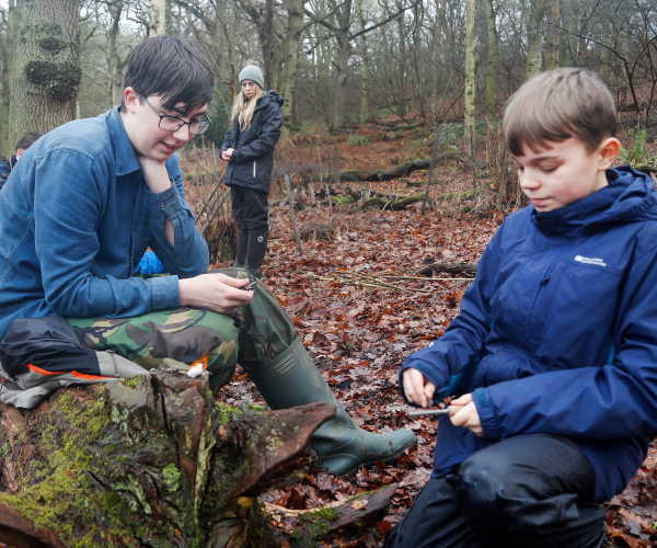 A couple of young foresters safely lighting flint in the Forest