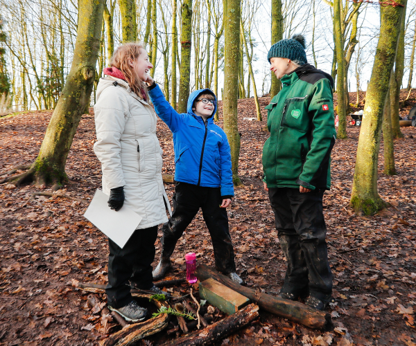 A mini forester, parent and member of staff having fun in the Forest