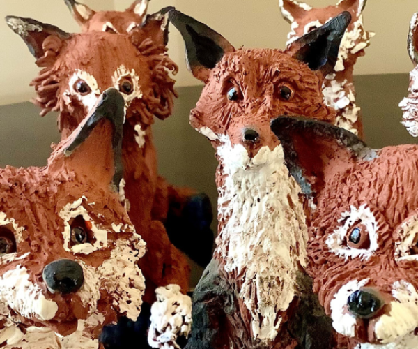 A group of newly made ceramic foxes from a previous workshop