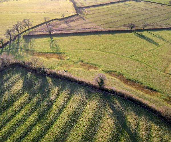 A drone image of the different habitats and land types of Naunton Beauchamp, furrows, arable land and SSSI 